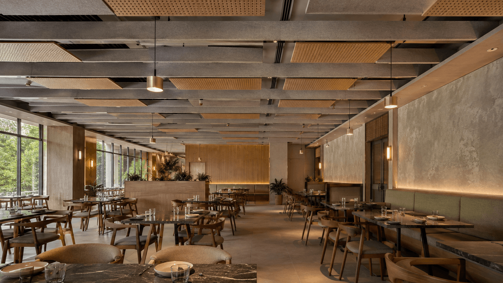 Restaurant ceiling with a beam grid and perforated acoustic panels to reduce echo and improve conversation clarity